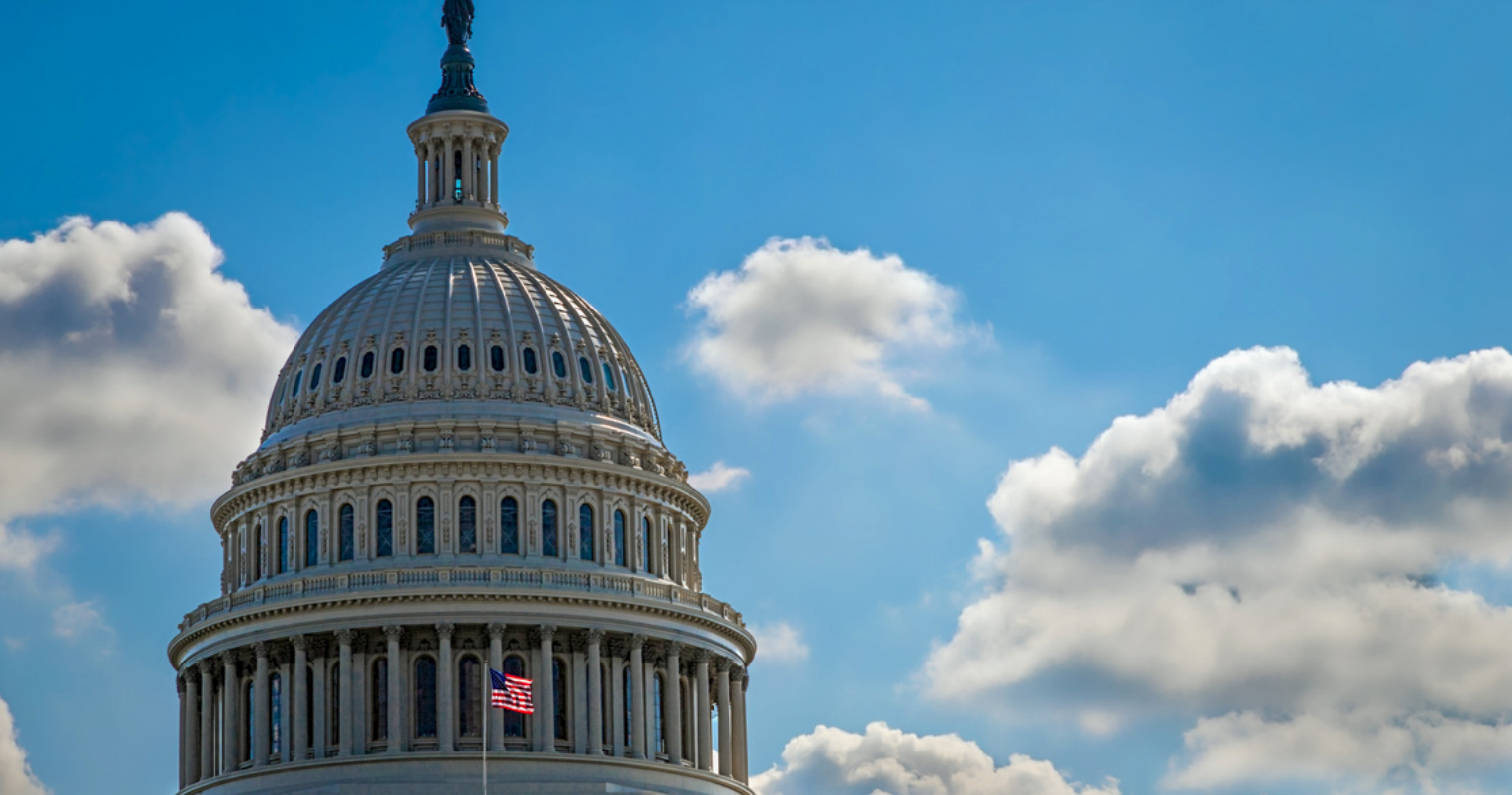 U.S Capitol building in front of a blue sky.