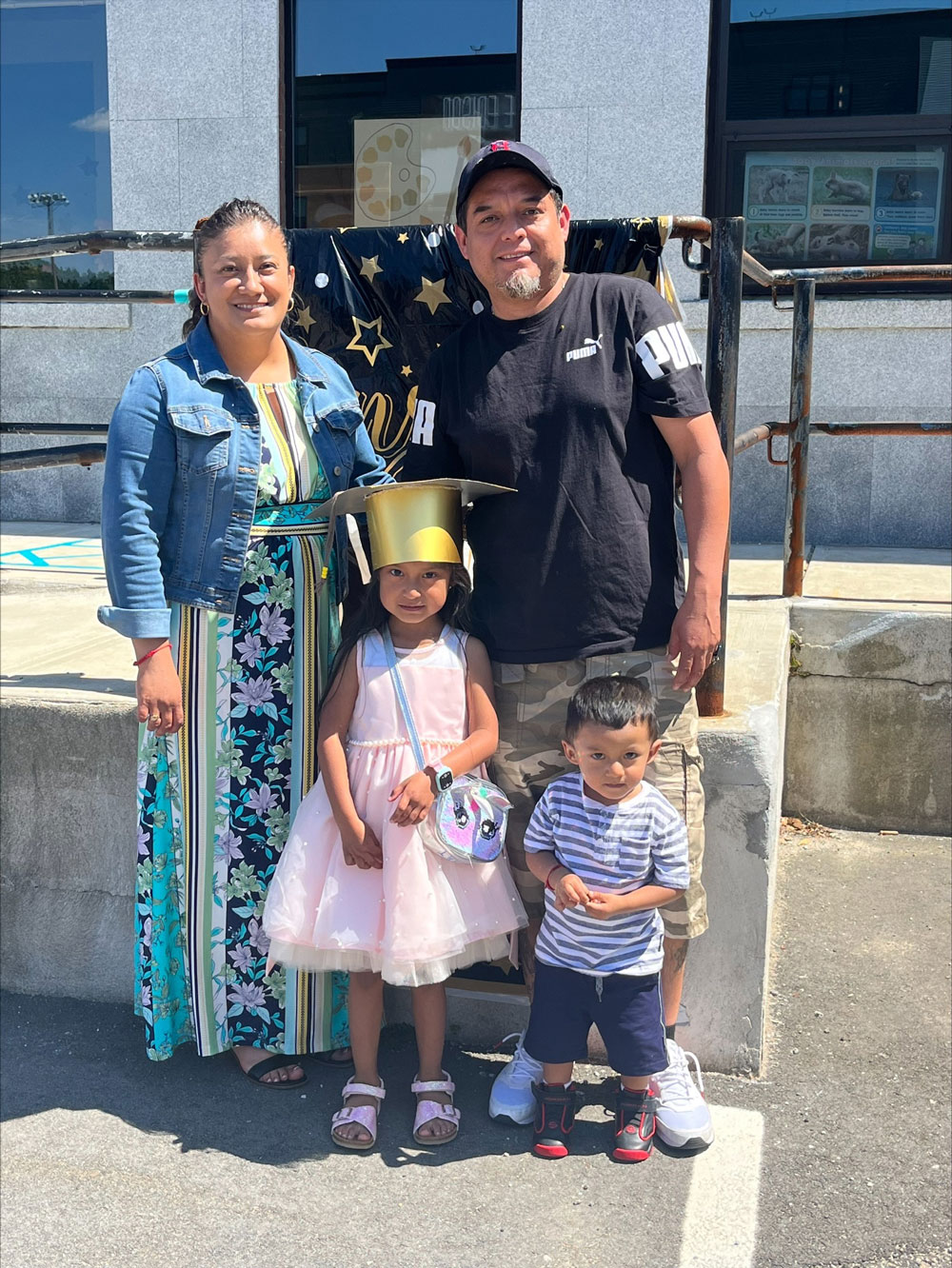 Guadalupe, her husband, and her children at her daughter Sofía's preschool graduation.